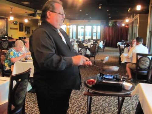A Server prepares a treat table-side at Crawdaddy's Restaurant in Visalia